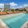 lounge chairs next to swimming pool