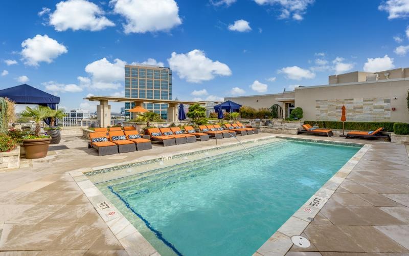 lounge chairs next to swimming pool