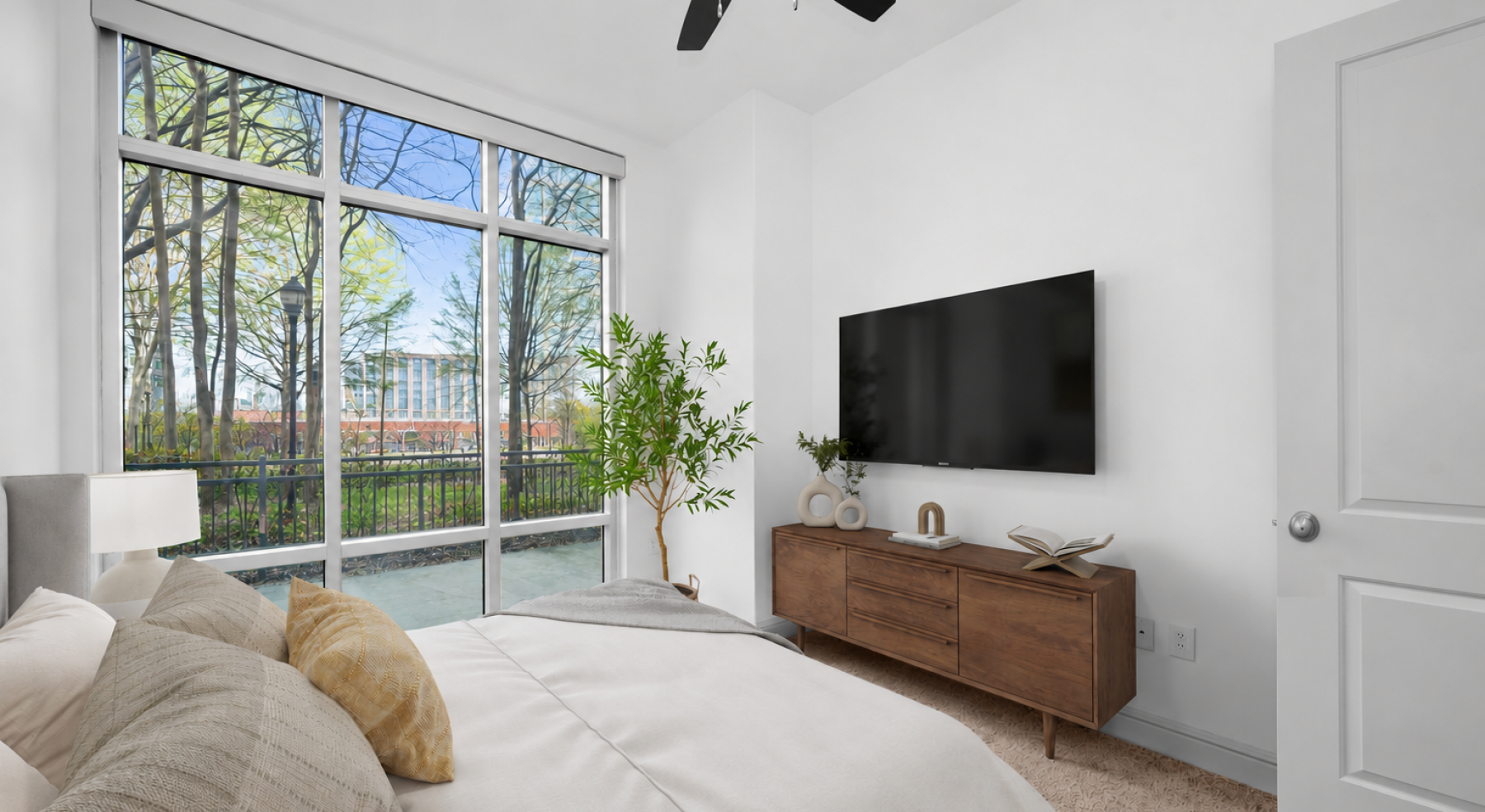 Bedroom with large windows and direct terrace access at Ashton South End apartments in Charlotte NC