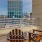 a deck with chairs and a view of a city
