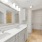 walk-in closet and dual sinks in bathroom