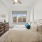large window brightens spacious bedroom