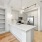 built-in bookshelves next to c-shaped kitchen