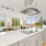 kitchen stove top built into island with overhead vent hood