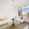 sun filled living room with city views