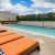 lounge on cushioned chairs, poolside