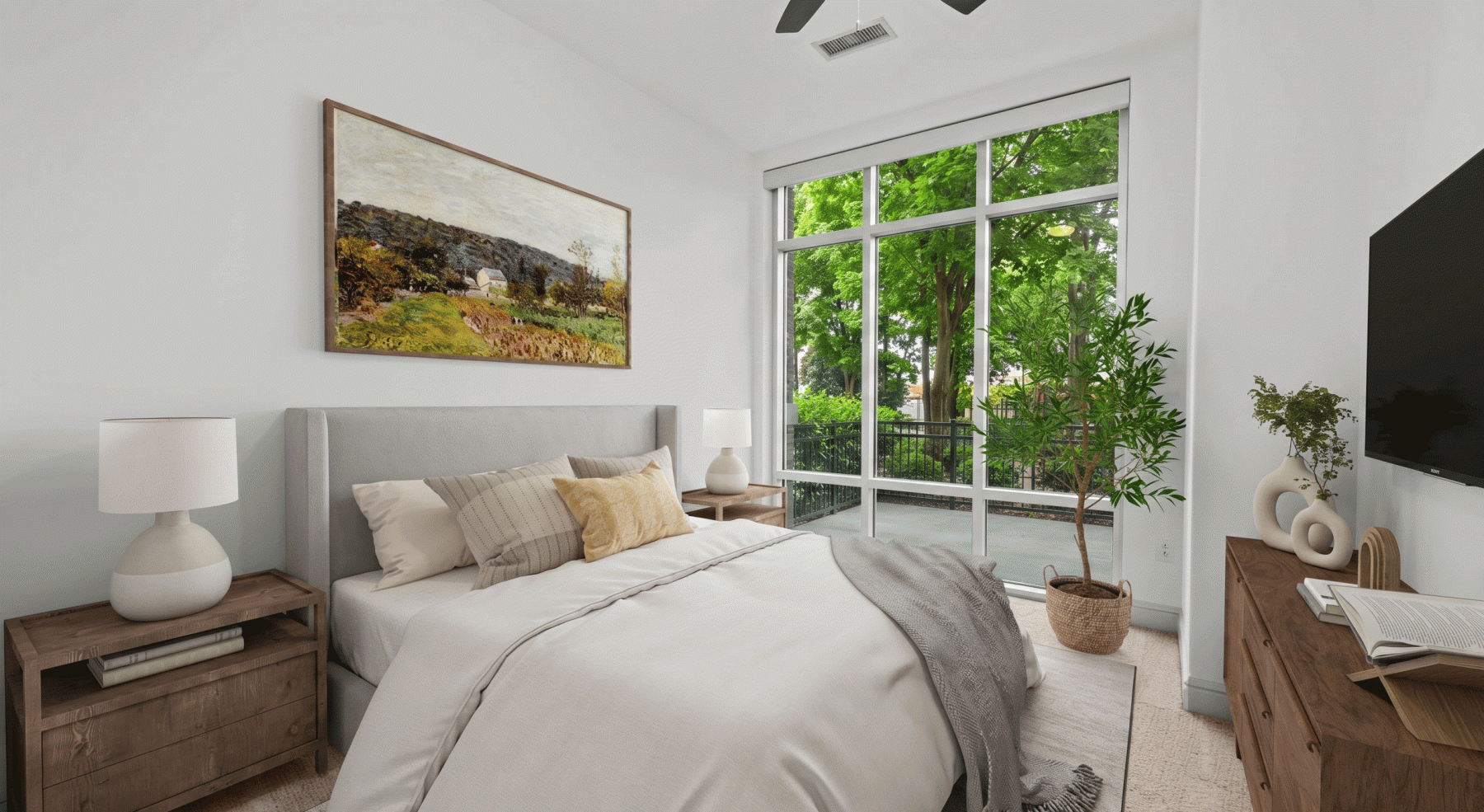Bedroom with large floor-to-ceiling windows and direct access to private terrace with tree views in South End Charlotte apartment